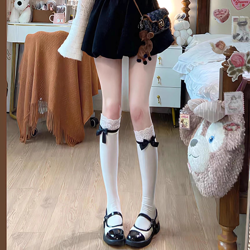 Inspired by the delicate aesthetic of Japanese Lolita fashion, these crew socks blend innocence with elegant charm. Soft lace trims and a delicate bow ribbon tie detail create a playful yet refined statement, perfect for adding a touch of kawaii sweetness to any outfit. Designed for comfort and style, they capture the dreamy, romantic essence of Harajuku street culture.