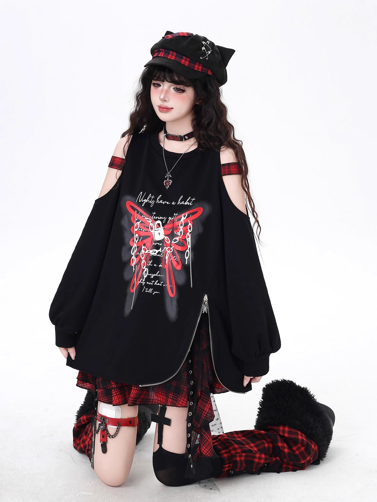 Edgy and feminine, this cropped hoodie features an off-shoulder cut and artistic butterfly-inspired detailing. The relaxed fit and asymmetrical hem create a modern silhouette, perfect for layering or wearing solo. Soft yet bold, it’s designed for those who balance delicate charm with urban toughness.