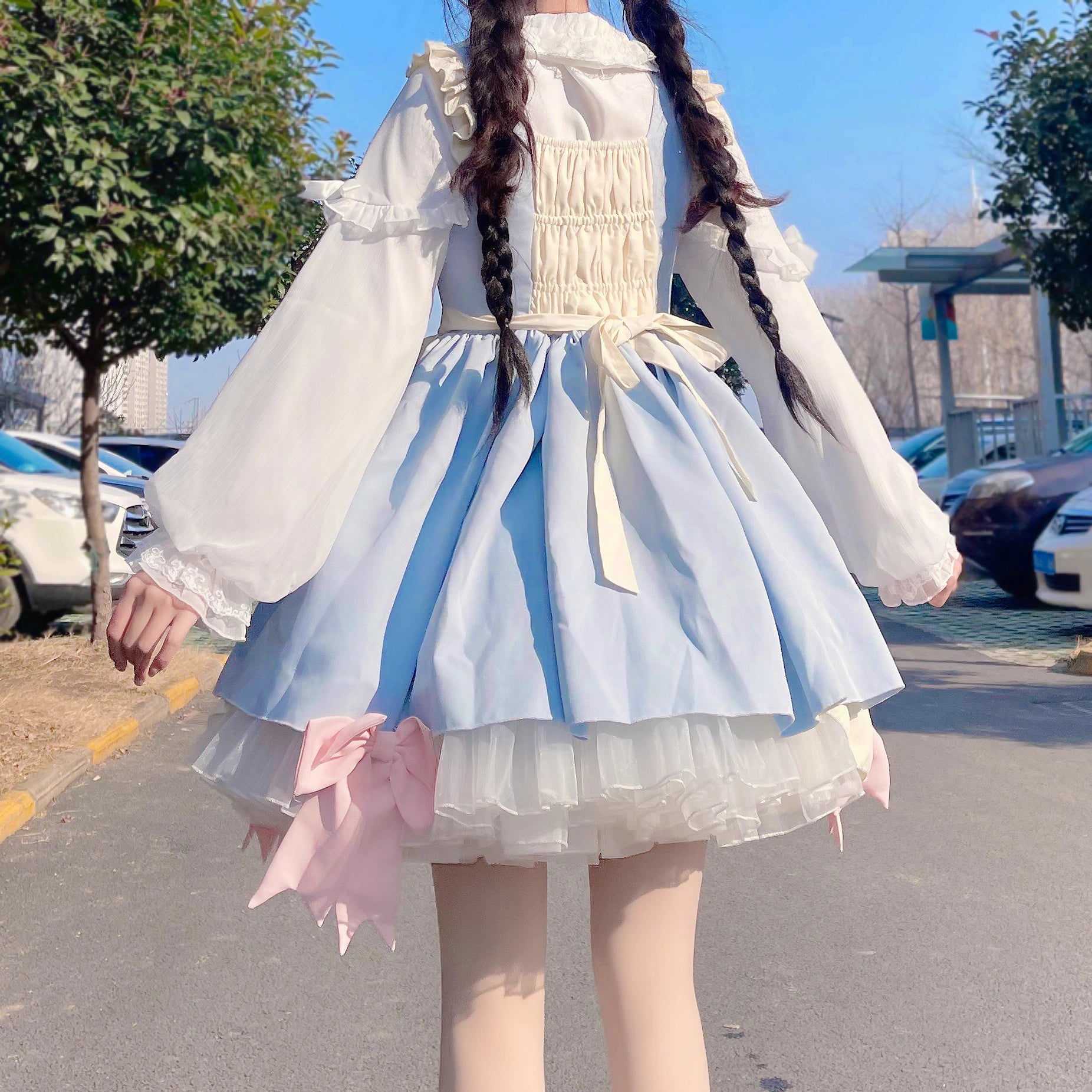 This classic Lolita blouse features a delicate Peter Pan collar and soft bishop sleeves with subtle puff detailing. Rendered in timeless black and white, its accordion pleats and bloom-inspired ruffles add vintage charm to any coordination. The lightweight fabric and tailored fit make it ideal for layering under jumpers or dresses, blending doll-like sweetness with elegant Gothic sophistication for daily wear or special occasions.