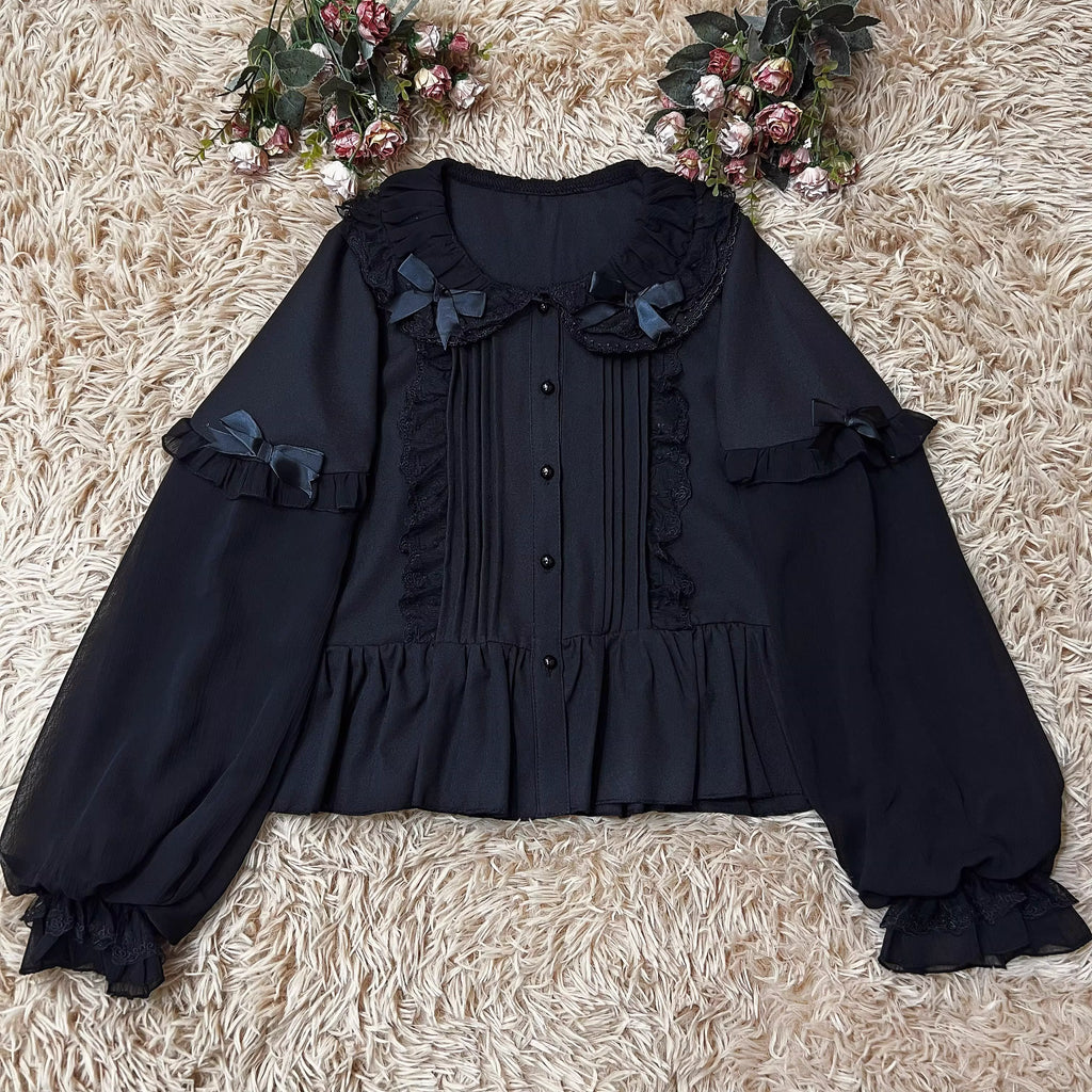 This classic Lolita blouse features a delicate Peter Pan collar and soft bishop sleeves with subtle puff detailing. Rendered in timeless black and white, its accordion pleats and bloom-inspired ruffles add vintage charm to any coordination. The lightweight fabric and tailored fit make it ideal for layering under jumpers or dresses, blending doll-like sweetness with elegant Gothic sophistication for daily wear or special occasions.