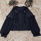 This classic Lolita blouse features a delicate Peter Pan collar and soft bishop sleeves with subtle puff detailing. Rendered in timeless black and white, its accordion pleats and bloom-inspired ruffles add vintage charm to any coordination. The lightweight fabric and tailored fit make it ideal for layering under jumpers or dresses, blending doll-like sweetness with elegant Gothic sophistication for daily wear or special occasions.