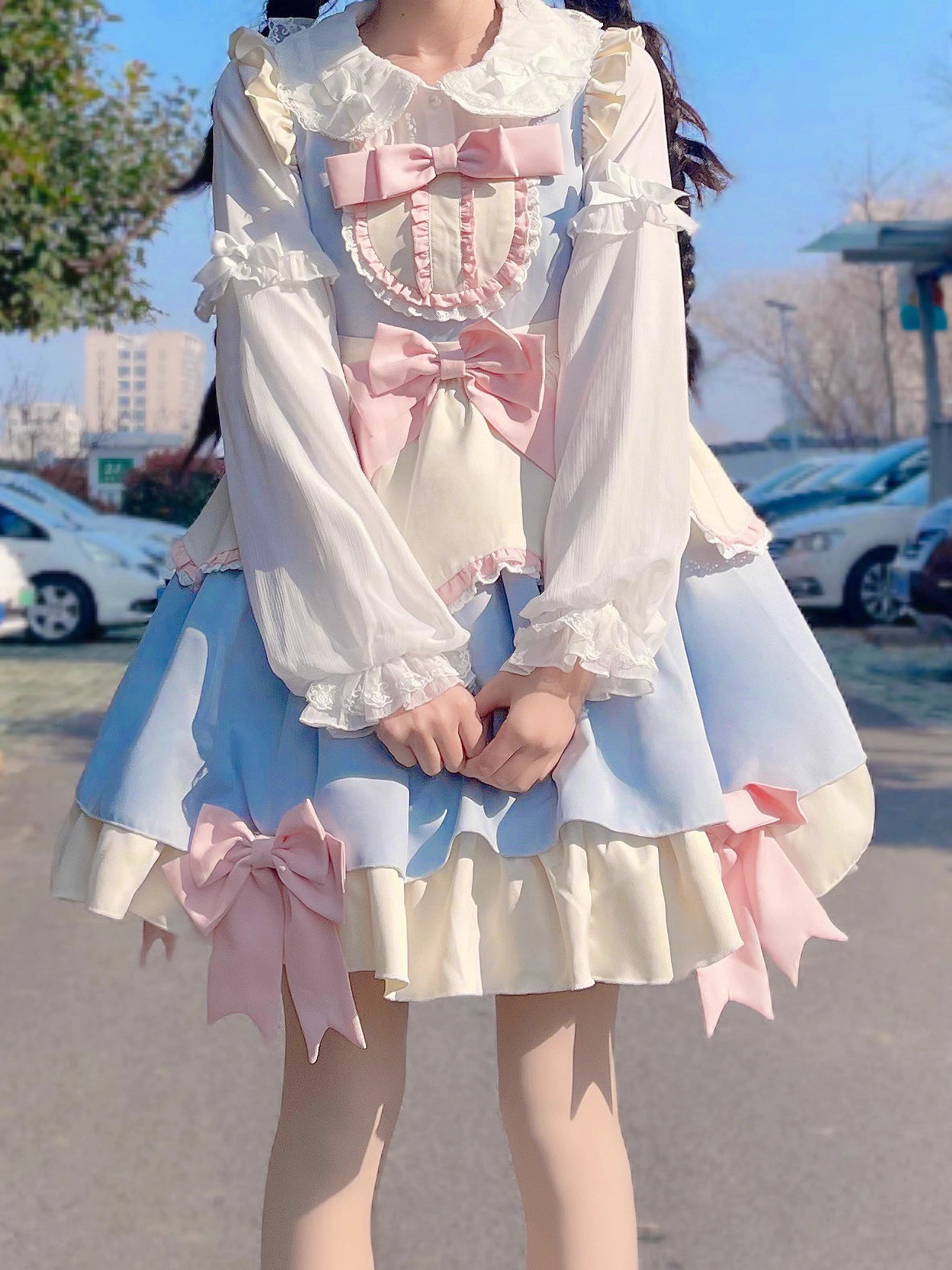 This classic Lolita blouse features a delicate Peter Pan collar and soft bishop sleeves with subtle puff detailing. Rendered in timeless black and white, its accordion pleats and bloom-inspired ruffles add vintage charm to any coordination. The lightweight fabric and tailored fit make it ideal for layering under jumpers or dresses, blending doll-like sweetness with elegant Gothic sophistication for daily wear or special occasions.