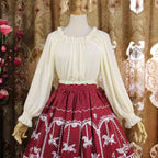 This lightweight chiffon blouse combines a classic round neck with soft puff sleeves for effortless elegance. The flowing fabric and relaxed silhouette offer versatile comfort, perfect for daily layering under jumpers or dresses. Its delicate drape and subtle sheen create a romantic foundation for both sweet and classic Lolita coordinates, blending practicality with dreamy sophistication.