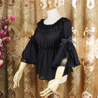 This elegant chiffon blouse features dramatic ruffled sleeves and a delicate bow accent, creating a romantic silhouette. The lightweight fabric drapes softly for effortless layering under jumpers or dresses. With its refined details and flowing texture, it blends vintage-inspired grace with modern Lolita charm, perfect for adding sophistication to any coordinate.