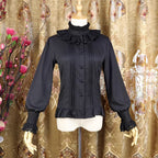 This vintage-inspired blouse features an elegant stand collar and delicate ruffled sleeves crafted from lightweight chiffon. The tailored fit and button-front design create a flattering silhouette, perfect for layering under jumpers or dresses. Its timeless elegance blends retro charm with Lolita sophistication, making it ideal for both classic and sweet coordinates.