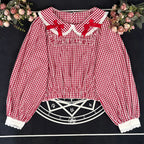 Crafted from breathable cotton, this charming short-sleeve blouse features a classic Peter Pan collar and delicate bow tie. The playful plaid pattern in multiple colors offers versatile styling for both Lolita and JK fashion. Its lightweight comfort and sweet design make it ideal for daily wear, effortlessly pairing with jumpers, skirts, or dresses for a fresh, youthful look.