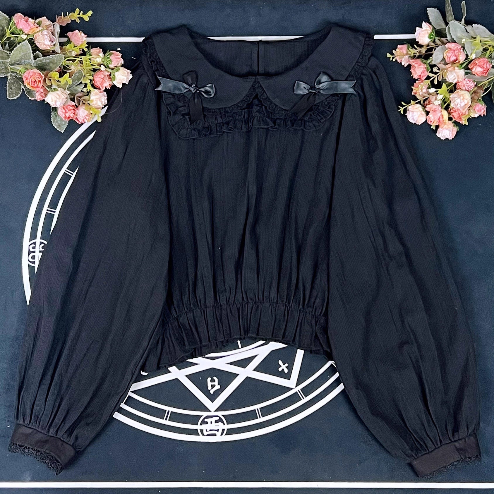 Crafted from breathable cotton, this charming short-sleeve blouse features a classic Peter Pan collar and delicate bow tie. The playful plaid pattern in multiple colors offers versatile styling for both Lolita and JK fashion. Its lightweight comfort and sweet design make it ideal for daily wear, effortlessly pairing with jumpers, skirts, or dresses for a fresh, youthful look.