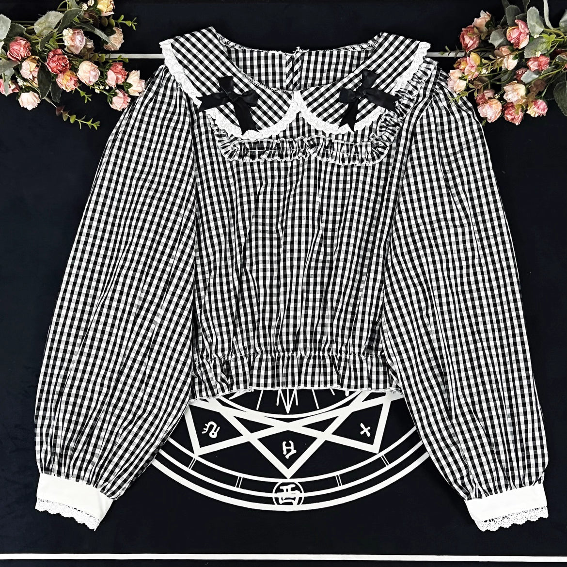 Crafted from breathable cotton, this charming short-sleeve blouse features a classic Peter Pan collar and delicate bow tie. The playful plaid pattern in multiple colors offers versatile styling for both Lolita and JK fashion. Its lightweight comfort and sweet design make it ideal for daily wear, effortlessly pairing with jumpers, skirts, or dresses for a fresh, youthful look.