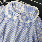 Crafted from breathable cotton, this charming short-sleeve blouse features a classic Peter Pan collar and delicate bow tie. The playful plaid pattern in multiple colors offers versatile styling for both Lolita and JK fashion. Its lightweight comfort and sweet design make it ideal for daily wear, effortlessly pairing with jumpers, skirts, or dresses for a fresh, youthful look.