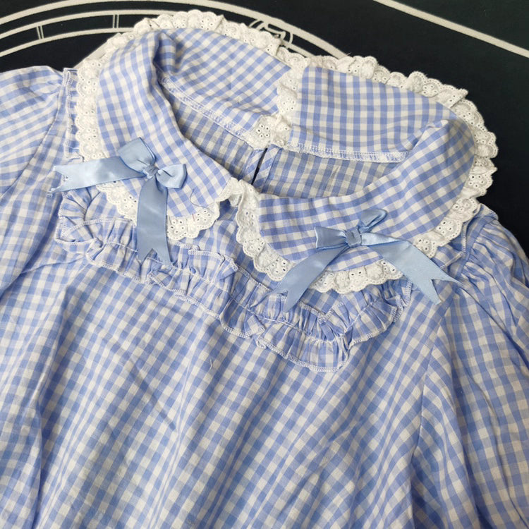 Crafted from breathable cotton, this charming short-sleeve blouse features a classic Peter Pan collar and delicate bow tie. The playful plaid pattern in multiple colors offers versatile styling for both Lolita and JK fashion. Its lightweight comfort and sweet design make it ideal for daily wear, effortlessly pairing with jumpers, skirts, or dresses for a fresh, youthful look.