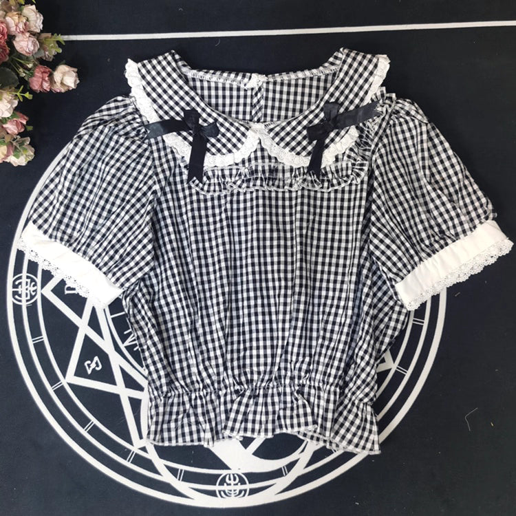 Crafted from breathable cotton, this charming short-sleeve blouse features a classic Peter Pan collar and delicate bow tie. The playful plaid pattern in multiple colors offers versatile styling for both Lolita and JK fashion. Its lightweight comfort and sweet design make it ideal for daily wear, effortlessly pairing with jumpers, skirts, or dresses for a fresh, youthful look.