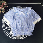 Crafted from breathable cotton, this charming short-sleeve blouse features a classic Peter Pan collar and delicate bow tie. The playful plaid pattern in multiple colors offers versatile styling for both Lolita and JK fashion. Its lightweight comfort and sweet design make it ideal for daily wear, effortlessly pairing with jumpers, skirts, or dresses for a fresh, youthful look.