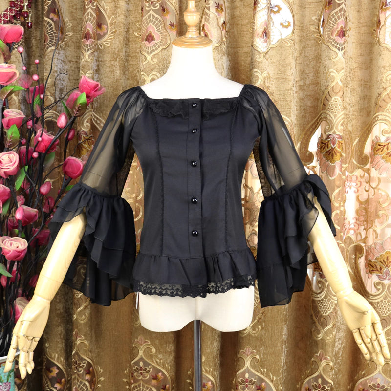 This elegant chiffon blouse combines a flattering square neckline with delicate off-shoulder styling and romantic puff sleeves. Crafted in classic black, its lightweight fabric and tailored fit create a sleek yet feminine silhouette. The three-quarter length sleeves and subtle ruffles add sophistication, making it perfect for layering under jumpers or pairing with high-waisted skirts for a timeless Lolita aesthetic.