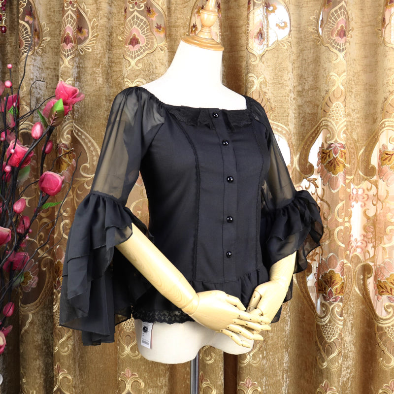 This elegant chiffon blouse combines a flattering square neckline with delicate off-shoulder styling and romantic puff sleeves. Crafted in classic black, its lightweight fabric and tailored fit create a sleek yet feminine silhouette. The three-quarter length sleeves and subtle ruffles add sophistication, making it perfect for layering under jumpers or pairing with high-waisted skirts for a timeless Lolita aesthetic.