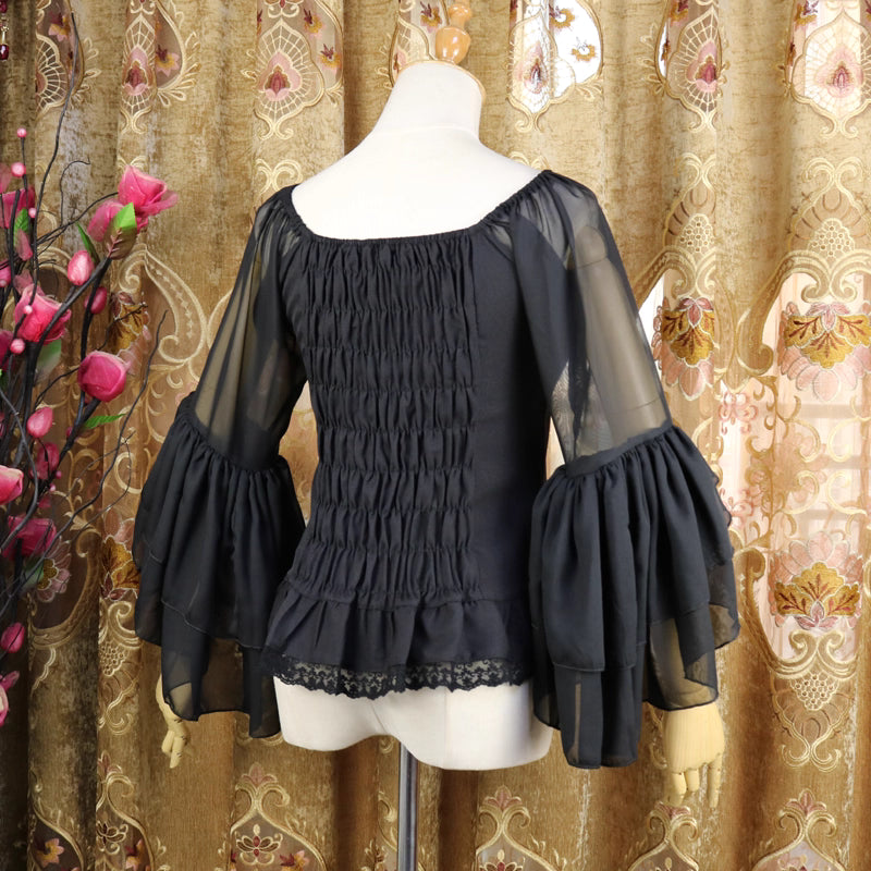 This elegant chiffon blouse combines a flattering square neckline with delicate off-shoulder styling and romantic puff sleeves. Crafted in classic black, its lightweight fabric and tailored fit create a sleek yet feminine silhouette. The three-quarter length sleeves and subtle ruffles add sophistication, making it perfect for layering under jumpers or pairing with high-waisted skirts for a timeless Lolita aesthetic.