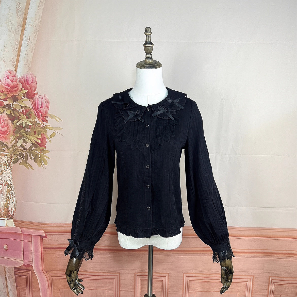 Crafted from soft cotton, this classic blouse features a charming Peter Pan collar adorned with a delicate bow. Rendered in versatile black, white, and peach, its breathable fabric and sweet design offer comfort for daily wear. The timeless elegance makes it perfect for layering under jumpers or dresses, blending practicality with romantic Lolita charm for year-round coordinations.