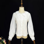 Crafted from soft cotton, this classic blouse features a charming Peter Pan collar adorned with a delicate bow. Rendered in versatile black, white, and peach, its breathable fabric and sweet design offer comfort for daily wear. The timeless elegance makes it perfect for layering under jumpers or dresses, blending practicality with romantic Lolita charm for year-round coordinations.