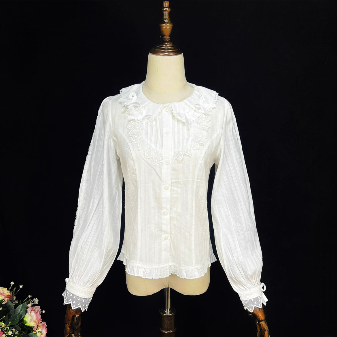 Crafted from soft cotton, this classic blouse features a charming Peter Pan collar adorned with a delicate bow. Rendered in versatile black, white, and peach, its breathable fabric and sweet design offer comfort for daily wear. The timeless elegance makes it perfect for layering under jumpers or dresses, blending practicality with romantic Lolita charm for year-round coordinations.