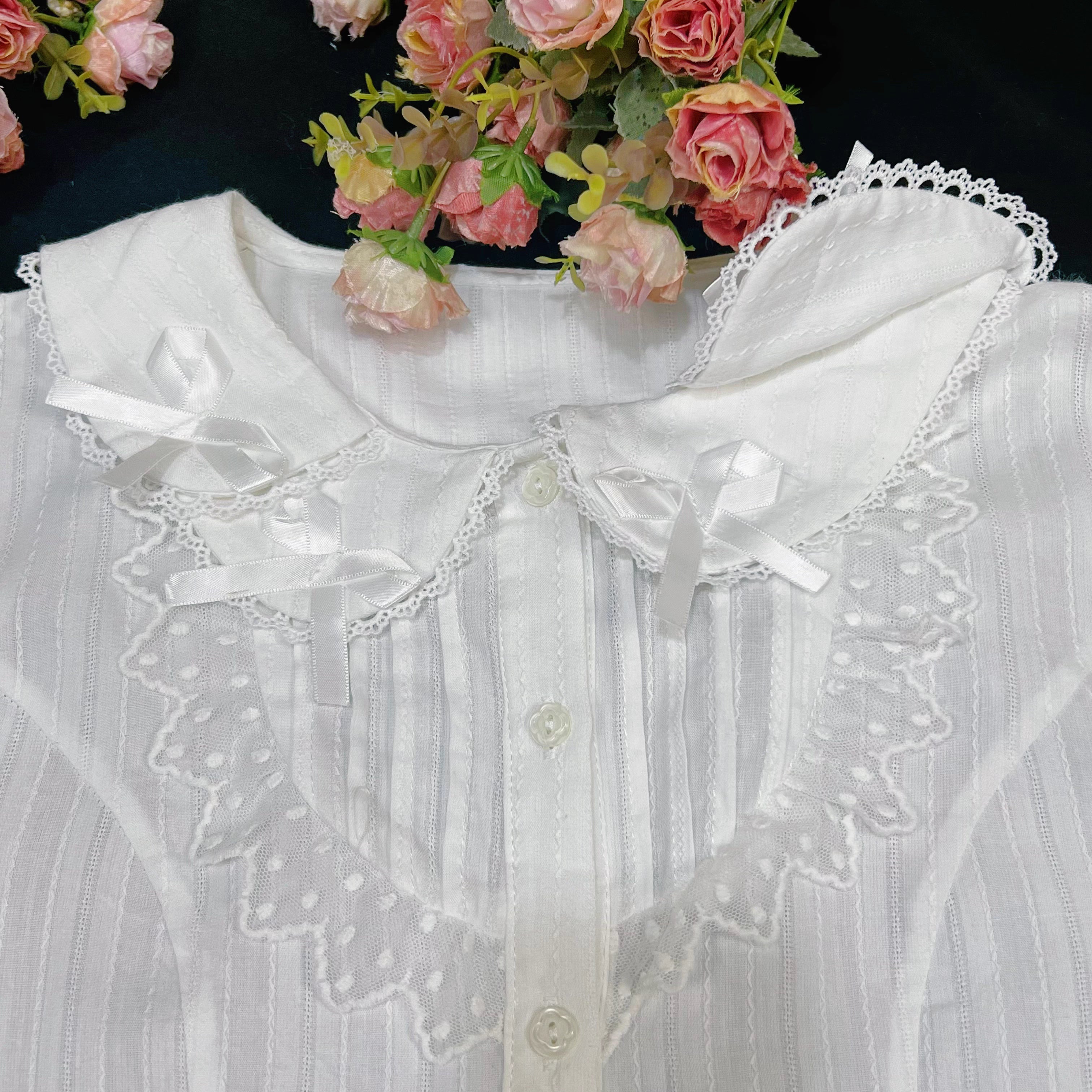 Crafted from soft cotton, this classic blouse features a charming Peter Pan collar adorned with a delicate bow. Rendered in versatile black, white, and peach, its breathable fabric and sweet design offer comfort for daily wear. The timeless elegance makes it perfect for layering under jumpers or dresses, blending practicality with romantic Lolita charm for year-round coordinations.