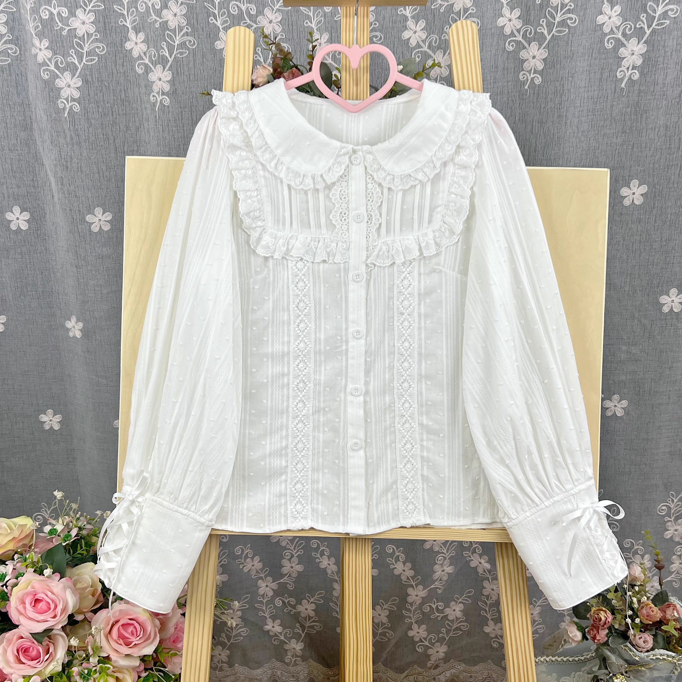 Design Concept:
This Lolita blouse is crafted from soft, breathable cotton, featuring a charming stand collar and long sleeves for a refined yet sweet look. Available in&nbsp;Beige, Black, and White, it combines classic Lolita elegance with a playful, doll-like aesthetic. The tailored silhouette and delicate detailing make it perfect for layering under jumpers, dresses, or wearing on its own for daily outings or tea parties.