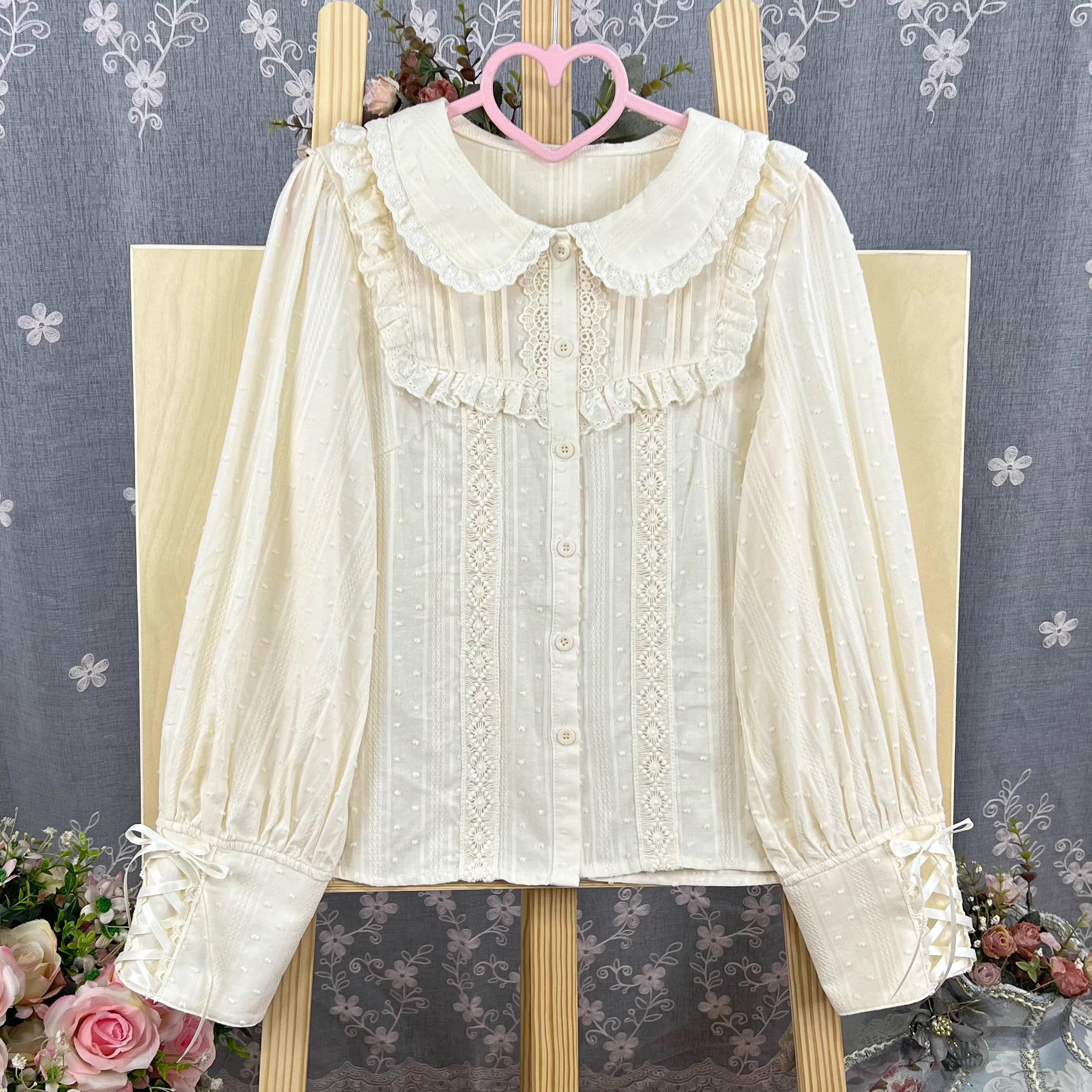 Design Concept:
This Lolita blouse is crafted from soft, breathable cotton, featuring a charming stand collar and long sleeves for a refined yet sweet look. Available in&nbsp;Beige, Black, and White, it combines classic Lolita elegance with a playful, doll-like aesthetic. The tailored silhouette and delicate detailing make it perfect for layering under jumpers, dresses, or wearing on its own for daily outings or tea parties.