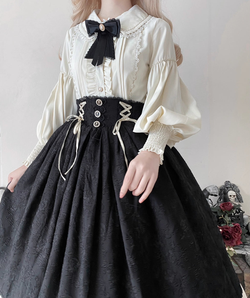 This Lolita blouse combines vintage CLA-inspired elegance with court-style sophistication. Featuring a delicate doll collar and refined tailoring, it adds a charming, graceful touch to any Lolita outfit. Available in Beige, Black, and White, this blouse is perfect as a layering piece under jumpers, dresses, or worn on its own for daily wear and tea parties.