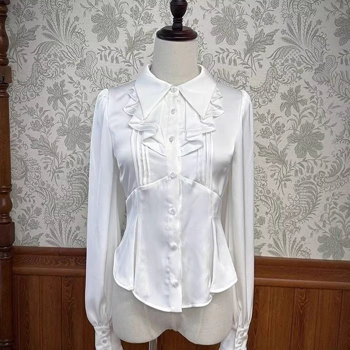 Inspired by the delicate charm of a dollhouse aesthetic, this long-sleeve Lolita blouse combines minimalist elegance with functional design. Crafted in pure white and classic black with a graceful drape, it features adjustable tie details for customizable silhouettes. The versatile piece offers a comfortable fit for daily wear, effortlessly layering under jumpers or pairing with high-waisted skirts. Its subtle sophistication makes it ideal for both sweet and Gothic Lolita coordinations, blending timeless pu