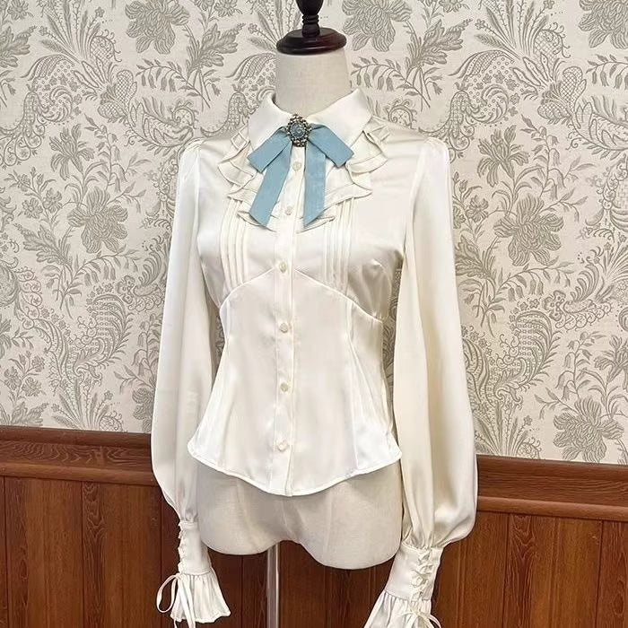 Inspired by the delicate charm of a dollhouse aesthetic, this long-sleeve Lolita blouse combines minimalist elegance with functional design. Crafted in pure white and classic black with a graceful drape, it features adjustable tie details for customizable silhouettes. The versatile piece offers a comfortable fit for daily wear, effortlessly layering under jumpers or pairing with high-waisted skirts. Its subtle sophistication makes it ideal for both sweet and Gothic Lolita coordinations, blending timeless pu
