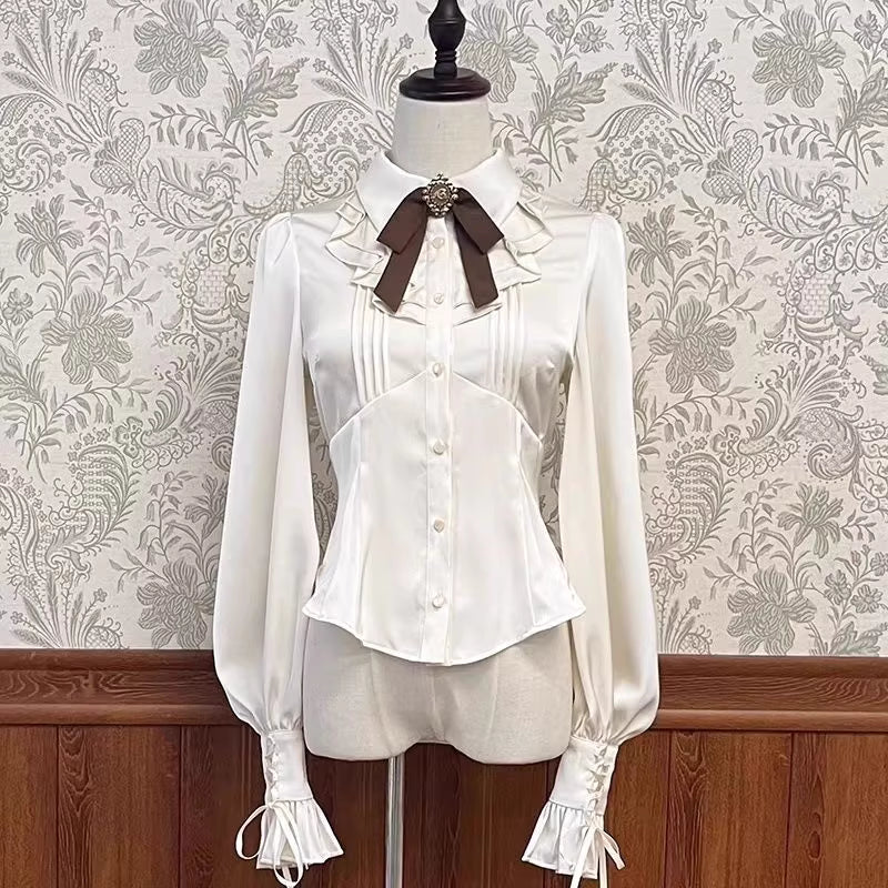 Inspired by the delicate charm of a dollhouse aesthetic, this long-sleeve Lolita blouse combines minimalist elegance with functional design. Crafted in pure white and classic black with a graceful drape, it features adjustable tie details for customizable silhouettes. The versatile piece offers a comfortable fit for daily wear, effortlessly layering under jumpers or pairing with high-waisted skirts. Its subtle sophistication makes it ideal for both sweet and Gothic Lolita coordinations, blending timeless pu