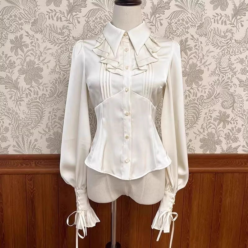 Inspired by the delicate charm of a dollhouse aesthetic, this long-sleeve Lolita blouse combines minimalist elegance with functional design. Crafted in pure white and classic black with a graceful drape, it features adjustable tie details for customizable silhouettes. The versatile piece offers a comfortable fit for daily wear, effortlessly layering under jumpers or pairing with high-waisted skirts. Its subtle sophistication makes it ideal for both sweet and Gothic Lolita coordinations, blending timeless pu