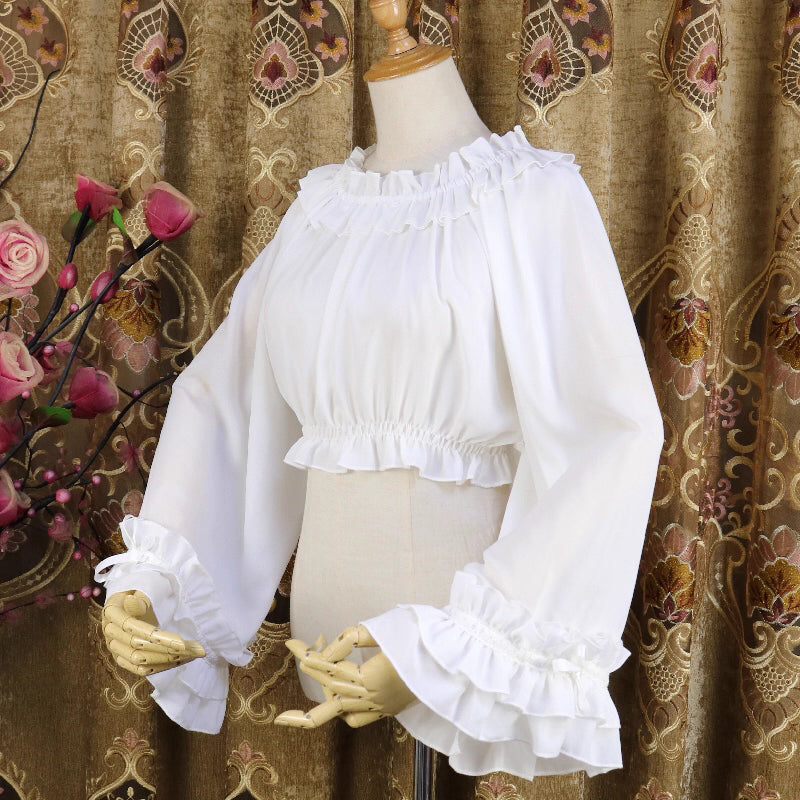 This flowing chiffon blouse combines delicate details with dramatic flared sleeves. Rendered in classic black, white, and bold red, its loose round neck design offers comfortable versatility for layering under JSKs or jumpers. The lightweight fabric and romantic silhouette create an elegant yet functional piece, perfect for adding dynamic movement and vintage charm to both sweet and Gothic Lolita coordinations.