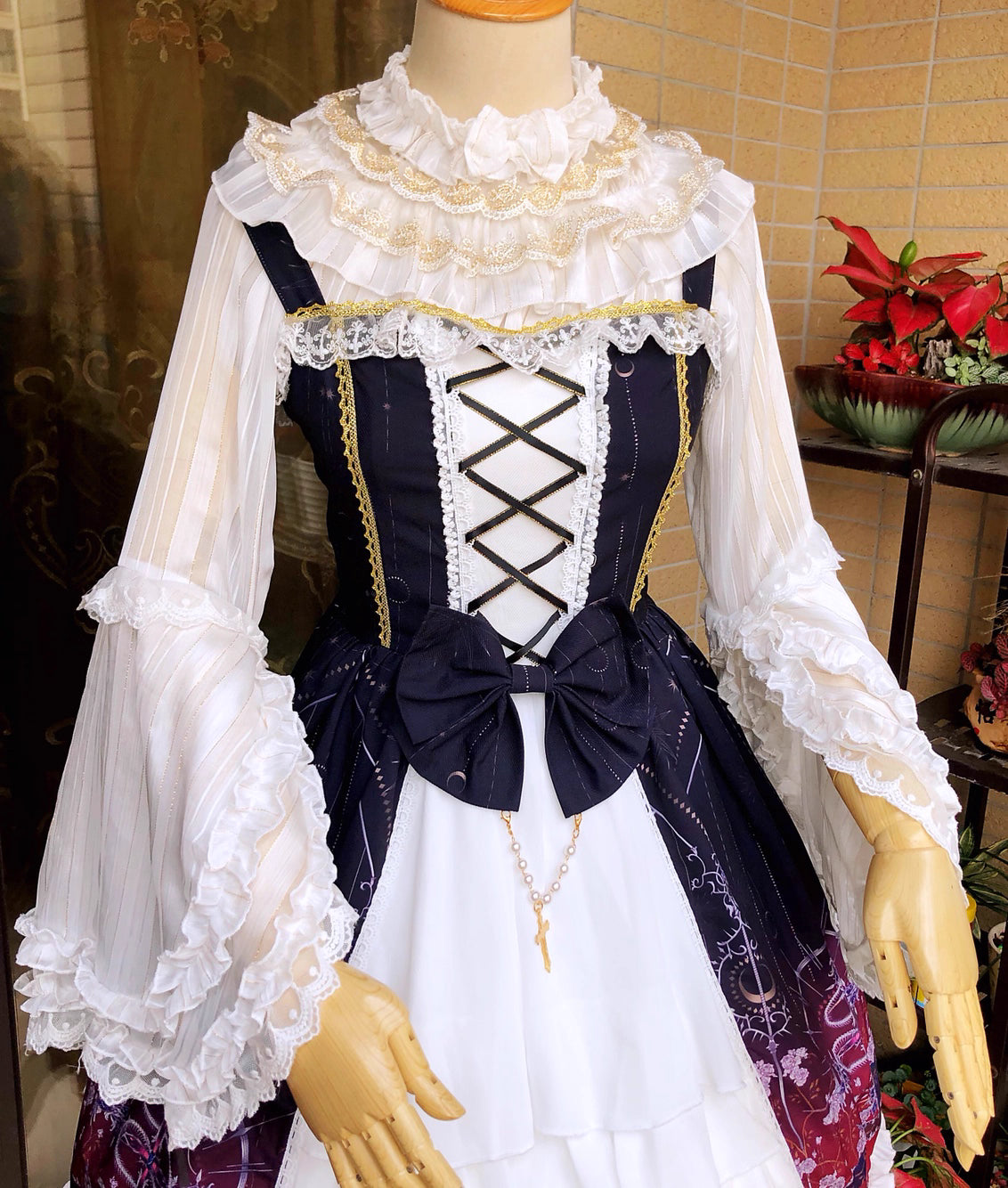 This elegant blouse combines luxurious gold-trimmed stripes with flowing chiffon fabric and dramatic sleeves. The metallic accents catch the light beautifully, adding opulence to the delicate striped pattern. Perfect for layering, it creates a sophisticated foundation for both classic and aristocratic Lolita styles, blending regal charm with timeless elegance.