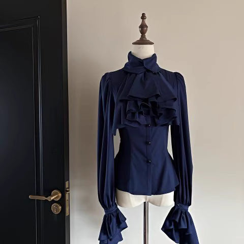 Step into Victorian elegance with this Gothic Lolita blouse. Delicate ruffles frame the Peter Pan collar and cascade down the front, while billowy bishop sleeves add dramatic flair. Crafted from premium opaque fabric, this retro-inspired top features intricate lace detailing and a tailored fit. Available in classic black, vampy red, and pristine white, it serves as the perfect layering piece for JSKs or a statement standalone top. Embrace dark romance with this timeless essential.