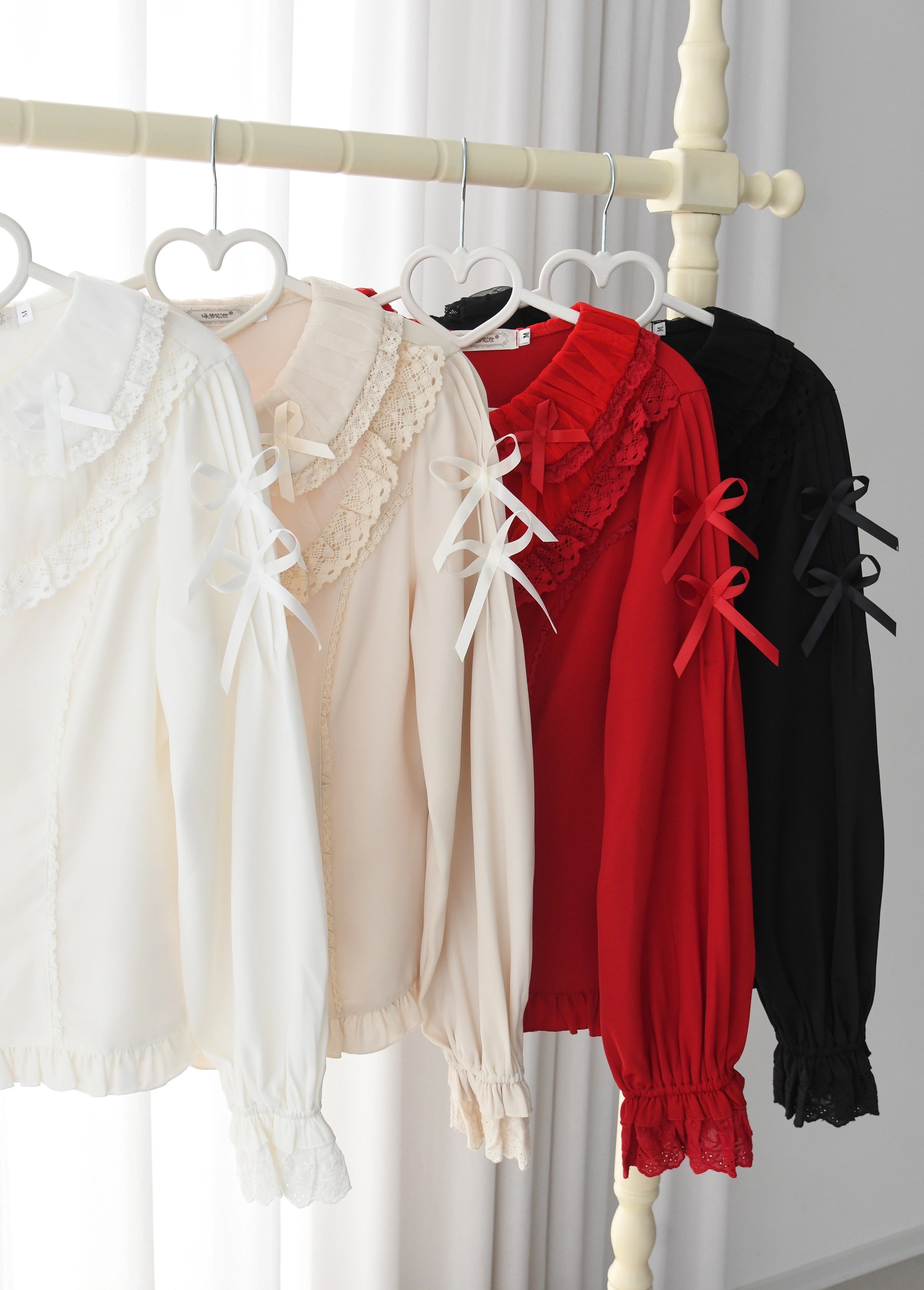 This exquisite Lolita blouse showcases a heavily detailed Peter Pan collar with intricate lace and embroidery. Rendered in vibrant red, pure white, and classic black, its long sleeves and tailored fit offer a perfect balance of sweetness and sophistication. The luxurious craftsmanship makes it ideal for creating striking coordinations, blending doll-like charm with elegant versatility for both daily wear and special occasions.