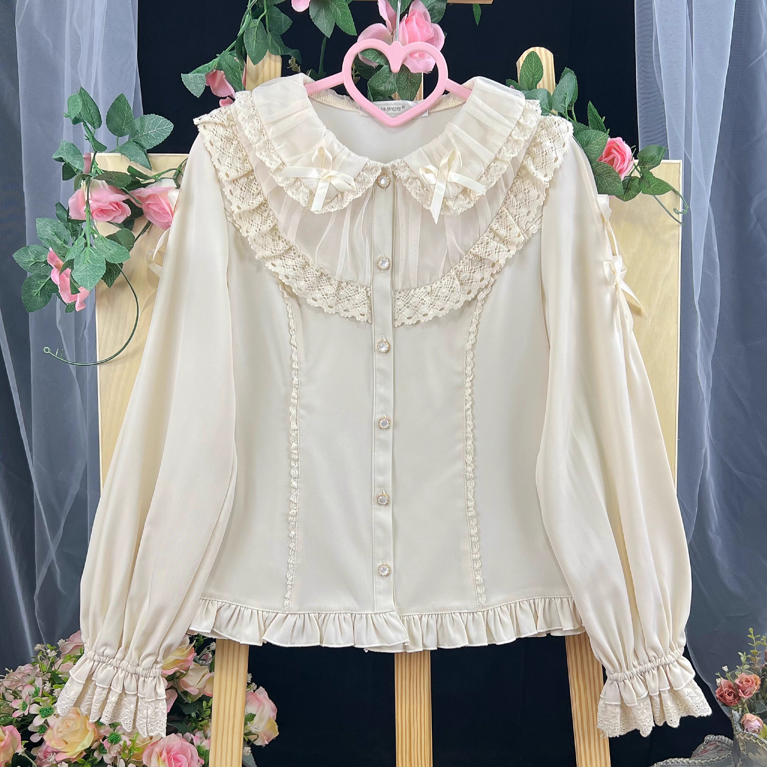This exquisite Lolita blouse showcases a heavily detailed Peter Pan collar with intricate lace and embroidery. Rendered in vibrant red, pure white, and classic black, its long sleeves and tailored fit offer a perfect balance of sweetness and sophistication. The luxurious craftsmanship makes it ideal for creating striking coordinations, blending doll-like charm with elegant versatility for both daily wear and special occasions.