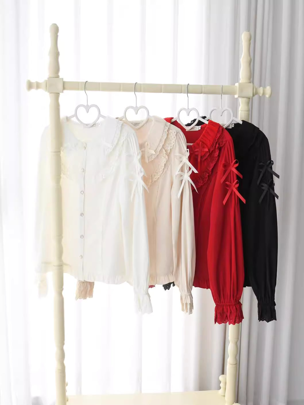 This exquisite Lolita blouse showcases a heavily detailed Peter Pan collar with intricate lace and embroidery. Rendered in vibrant red, pure white, and classic black, its long sleeves and tailored fit offer a perfect balance of sweetness and sophistication. The luxurious craftsmanship makes it ideal for creating striking coordinations, blending doll-like charm with elegant versatility for both daily wear and special occasions.