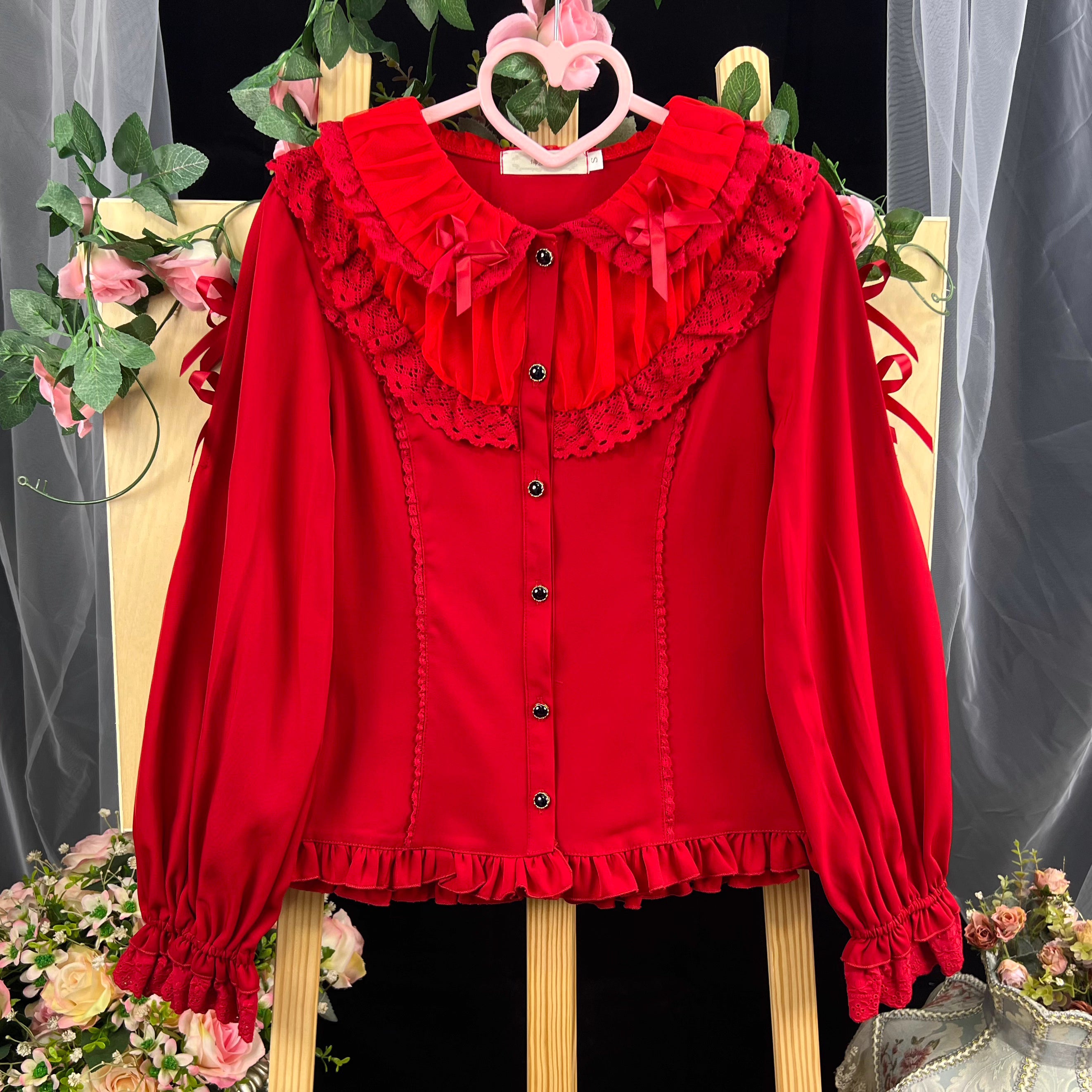 This exquisite Lolita blouse showcases a heavily detailed Peter Pan collar with intricate lace and embroidery. Rendered in vibrant red, pure white, and classic black, its long sleeves and tailored fit offer a perfect balance of sweetness and sophistication. The luxurious craftsmanship makes it ideal for creating striking coordinations, blending doll-like charm with elegant versatility for both daily wear and special occasions.