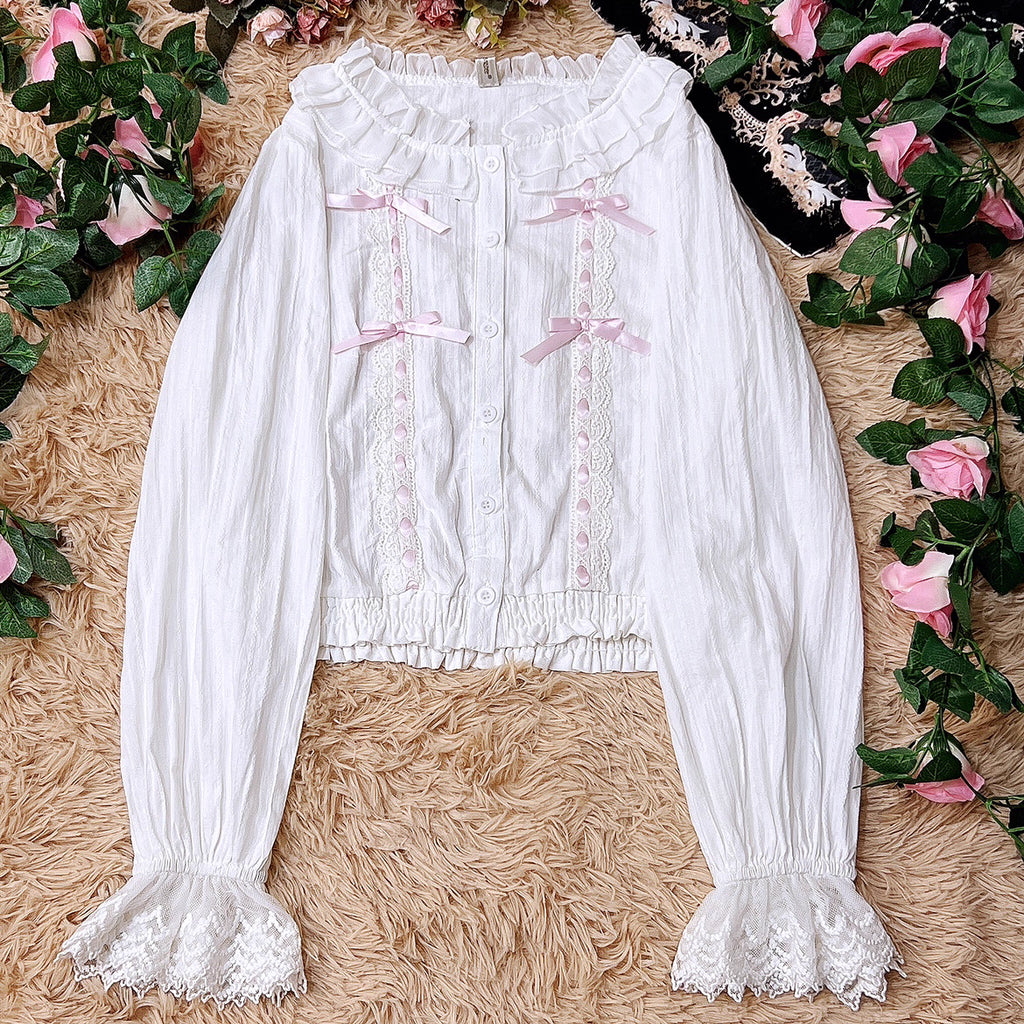 This short-cut cotton blouse features a flattering high-waist design and an elastic hem adorned with delicate ruffles. Crafted in versatile black and sweet pink, its breathable fabric and tailored fit offer comfort for daily wear. The cropped length perfectly pairs with high-waisted skirts or jumpers, blending playful charm with practical elegance for cute Lolita coordinates.