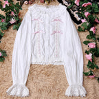 This short-cut cotton blouse features a flattering high-waist design and an elastic hem adorned with delicate ruffles. Crafted in versatile black and sweet pink, its breathable fabric and tailored fit offer comfort for daily wear. The cropped length perfectly pairs with high-waisted skirts or jumpers, blending playful charm with practical elegance for cute Lolita coordinates.