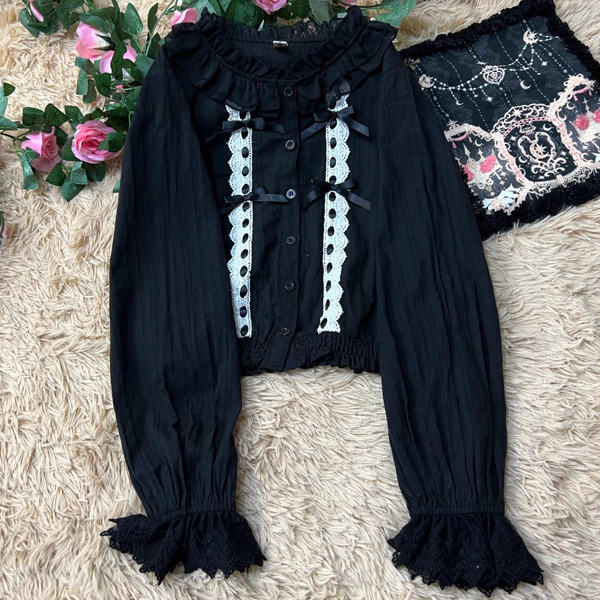 This short-cut cotton blouse features a flattering high-waist design and an elastic hem adorned with delicate ruffles. Crafted in versatile black and sweet pink, its breathable fabric and tailored fit offer comfort for daily wear. The cropped length perfectly pairs with high-waisted skirts or jumpers, blending playful charm with practical elegance for cute Lolita coordinates.