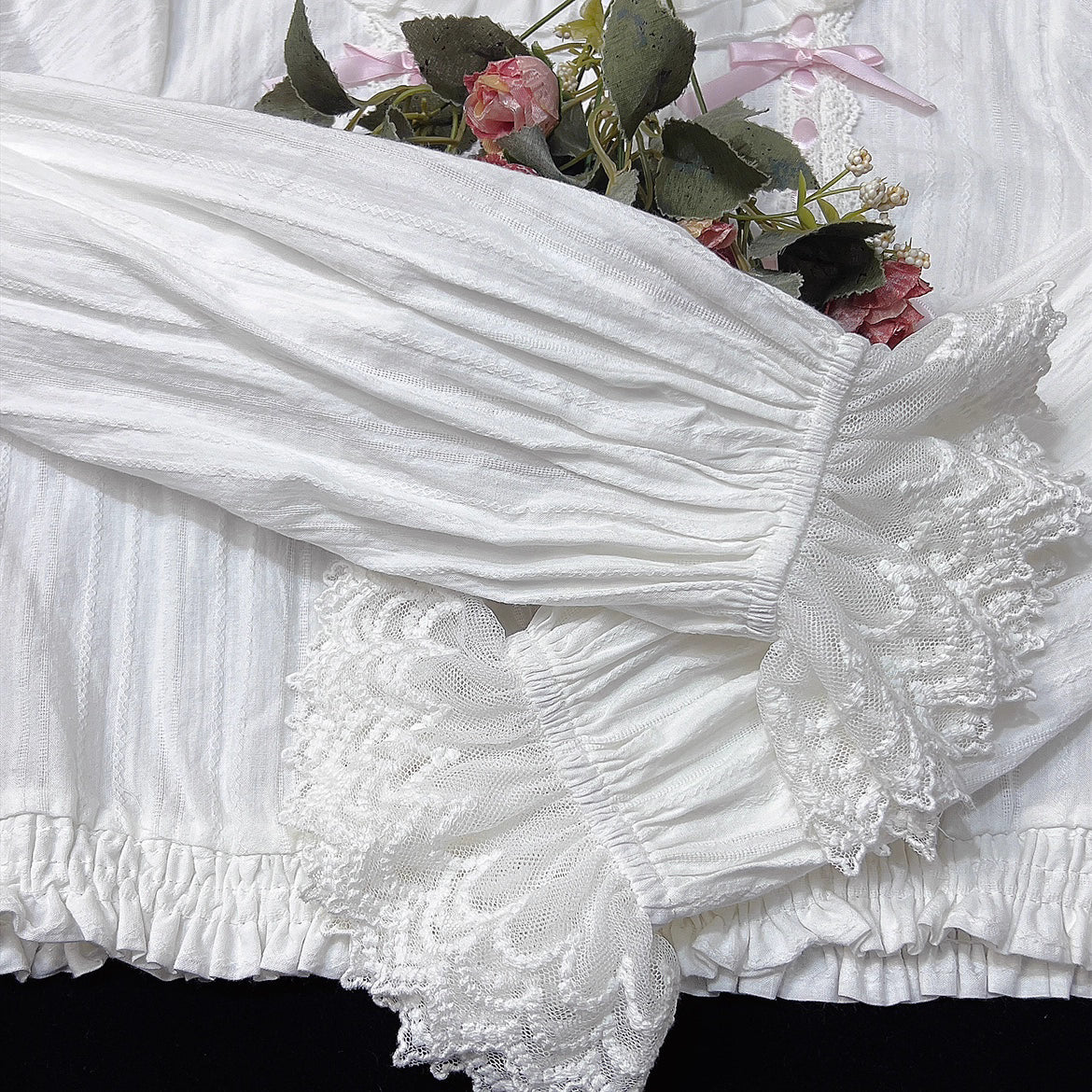 This short-cut cotton blouse features a flattering high-waist design and an elastic hem adorned with delicate ruffles. Crafted in versatile black and sweet pink, its breathable fabric and tailored fit offer comfort for daily wear. The cropped length perfectly pairs with high-waisted skirts or jumpers, blending playful charm with practical elegance for cute Lolita coordinates.