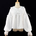 Embodying the freshness of spring, this delicate blouse features a lace-trimmed doll collar adorned with satin ribbons and soft bishop sleeves. The lightweight fabric and sweet design make it perfect for layering under jumpers or dresses. Its romantic details capture a whimsical, youthful charm, ideal for creating enchanting coordinations that blend vintage elegance with modern Lolita sweetness.