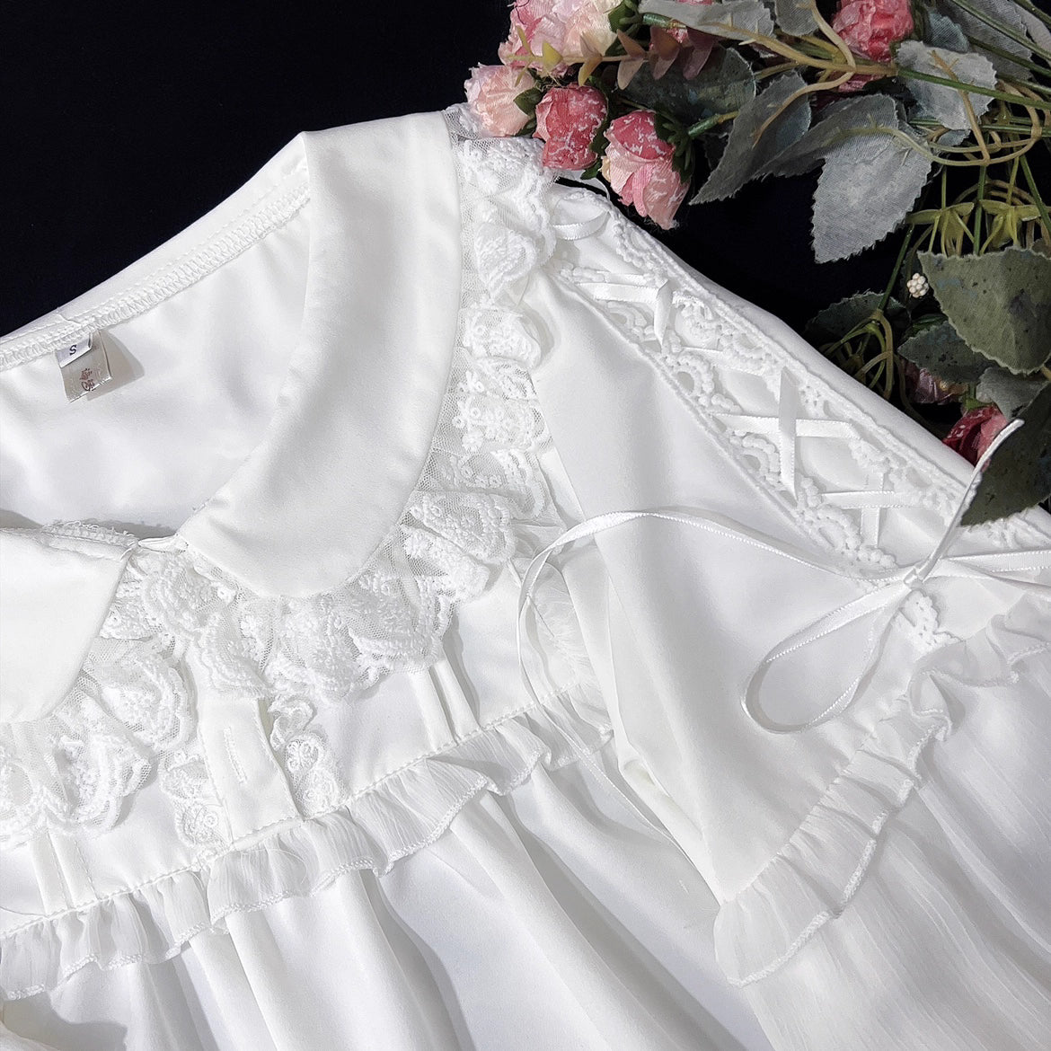 Embodying the freshness of spring, this delicate blouse features a lace-trimmed doll collar adorned with satin ribbons and soft bishop sleeves. The lightweight fabric and sweet design make it perfect for layering under jumpers or dresses. Its romantic details capture a whimsical, youthful charm, ideal for creating enchanting coordinations that blend vintage elegance with modern Lolita sweetness.