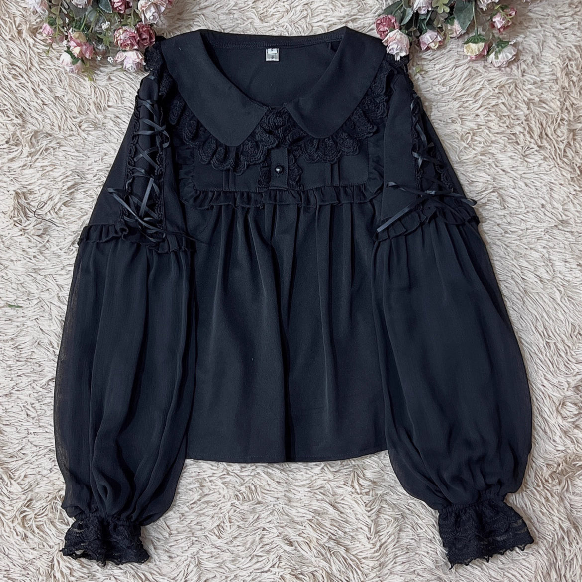 Embodying the freshness of spring, this delicate blouse features a lace-trimmed doll collar adorned with satin ribbons and soft bishop sleeves. The lightweight fabric and sweet design make it perfect for layering under jumpers or dresses. Its romantic details capture a whimsical, youthful charm, ideal for creating enchanting coordinations that blend vintage elegance with modern Lolita sweetness.