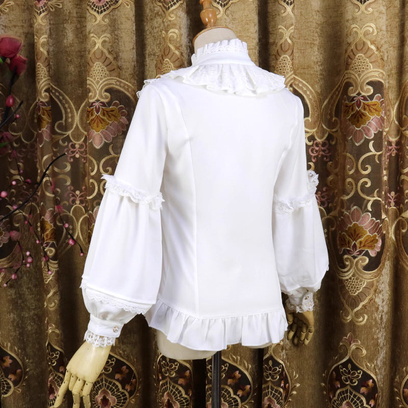 This vintage-inspired blouse features an elegant stand collar and voluminous lantern sleeves crafted from lightweight chiffon. The tailored silhouette offers a flattering fit, while delicate lace details add romantic refinement. Perfect for layering under dresses or jumpers, it blends retro sophistication with Lolita elegance, creating a timeless foundation for both classic and sweet coordinates.