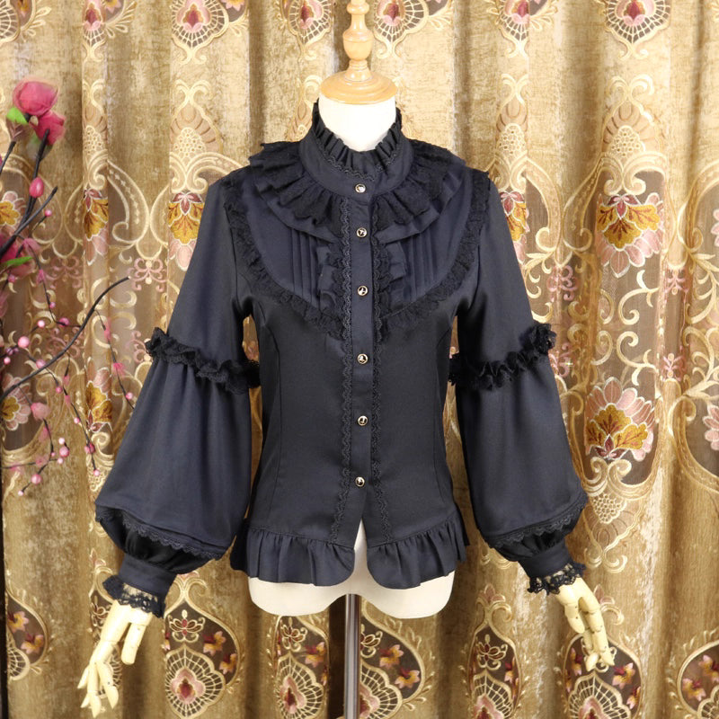 This vintage-inspired blouse features an elegant stand collar and voluminous lantern sleeves crafted from lightweight chiffon. The tailored silhouette offers a flattering fit, while delicate lace details add romantic refinement. Perfect for layering under dresses or jumpers, it blends retro sophistication with Lolita elegance, creating a timeless foundation for both classic and sweet coordinates.