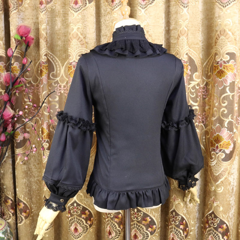 This vintage-inspired blouse features an elegant stand collar and voluminous lantern sleeves crafted from lightweight chiffon. The tailored silhouette offers a flattering fit, while delicate lace details add romantic refinement. Perfect for layering under dresses or jumpers, it blends retro sophistication with Lolita elegance, creating a timeless foundation for both classic and sweet coordinates.