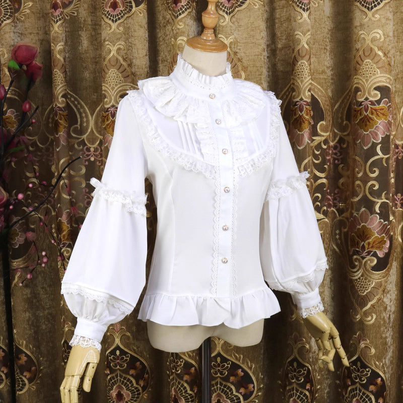 This vintage-inspired blouse features an elegant stand collar and voluminous lantern sleeves crafted from lightweight chiffon. The tailored silhouette offers a flattering fit, while delicate lace details add romantic refinement. Perfect for layering under dresses or jumpers, it blends retro sophistication with Lolita elegance, creating a timeless foundation for both classic and sweet coordinates.