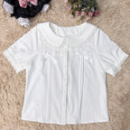 Designed for summer comfort, this sweet Lolita blouse features a classic Peter Pan collar and breezy short sleeves. The lightweight fabric and playful design make it perfect for both casual JK styles and cute Lolita coordinates. Its versatile charm blends effortless daily wear with dreamy elegance, offering a fresh and youthful look for warm-weather fashion.
