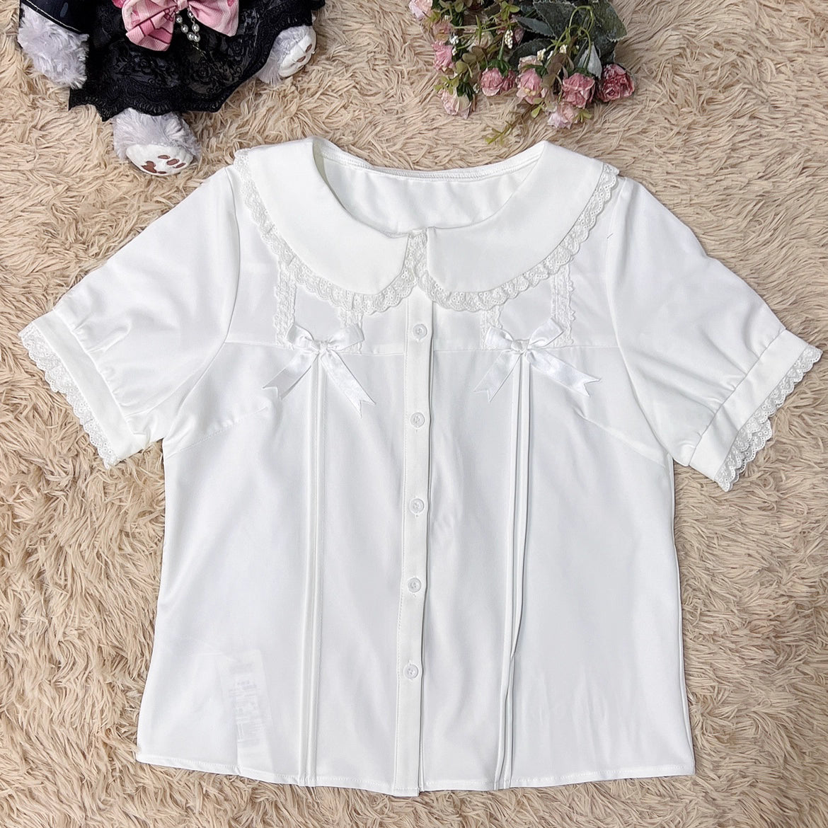 Designed for summer comfort, this sweet Lolita blouse features a classic Peter Pan collar and breezy short sleeves. The lightweight fabric and playful design make it perfect for both casual JK styles and cute Lolita coordinates. Its versatile charm blends effortless daily wear with dreamy elegance, offering a fresh and youthful look for warm-weather fashion.